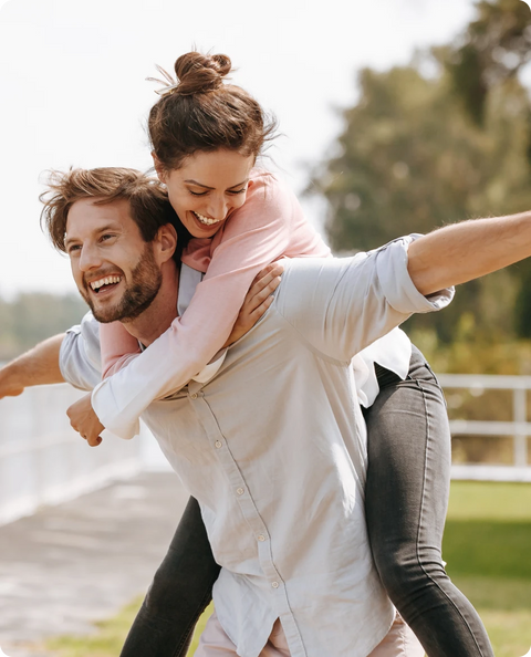 A happy couple enjoying a date while sharing a pack of sea moss gummies
