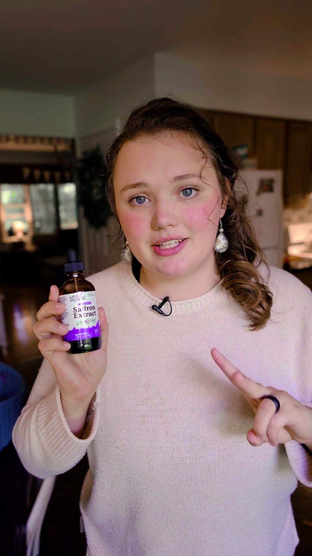 Creator holding the Saffron Extract bottle